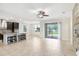 Open-concept living area with a view of the modern kitchen, dining space, and access to the outdoors at 1830 Nature View Dr, Lutz, FL 33558