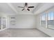 Spacious main bedroom with tray ceiling, ceiling fan and plenty of natural light from windows at 1830 Nature View Dr, Lutz, FL 33558