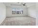 Spacious main bedroom featuring tray ceilings, ceiling fan and lots of natural light at 1830 Nature View Dr, Lutz, FL 33558