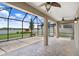 Covered patio with brick pavers, ceiling fans, and a beautiful backyard view at 1830 Nature View Dr, Lutz, FL 33558
