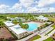 Aerial view of the community pool and recreation area with palm trees and lounge chairs under sunny skies at 1830 Nature View Dr, Lutz, FL 33558