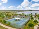 Aerial view of the community tennis courts next to the lake and other amenities at 1830 Nature View Dr, Lutz, FL 33558