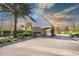 Stone-accented entrance to community with mature trees and lush landscaping on a paver road at 18819 Rue Loire St, Lutz, FL 33558
