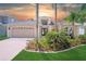 Charming one story home featuring mature landscaping, neutral colors, large driveway, and two car garage at 18819 Rue Loire St, Lutz, FL 33558