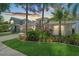Beautiful one story home featuring mature landscaping, neutral colors, large driveway, and two car garage at 18819 Rue Loire St, Lutz, FL 33558