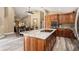 Modern kitchen features stainless steel appliances, a large granite island, and a view into the dining area at 18819 Rue Loire St, Lutz, FL 33558