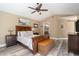 Cozy main bedroom with wood accents, a ceiling fan, and an ensuite bathroom at 18819 Rue Loire St, Lutz, FL 33558