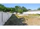 Spacious fenced backyard with shed, patio, and mature trees offers privacy and room for recreation at 1939 Heartland Cir, Valrico, FL 33594