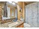 Bathroom featuring a granite countertop vanity, a decorative mirror, and patterned shower curtain at 1939 Heartland Cir, Valrico, FL 33594