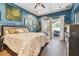Stylish bedroom with hardwood floors, plenty of wall decor, and access to screened patio at 1939 Heartland Cir, Valrico, FL 33594