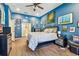 Spacious bedroom with hardwood floors, a ceiling fan, and decorative wall paintings at 1939 Heartland Cir, Valrico, FL 33594