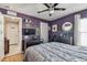 A well-lit bedroom boasts a modern ceiling fan, sleek furniture, and contemporary design at 1939 Heartland Cir, Valrico, FL 33594