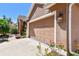 Attached two-car garage featuring neutral color and beautiful exterior wall lamp at 1939 Heartland Cir, Valrico, FL 33594