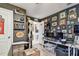 Home office boasts shelves, dark walls covered with framed pictures, a desk and computer monitor at 1939 Heartland Cir, Valrico, FL 33594