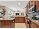 Modern kitchen featuring dark cabinets, granite countertops, stainless steel appliances, and open layout at 1939 Heartland Cir, Valrico, FL 33594