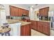 Spacious kitchen featuring dark wood cabinets, granite countertops, and stainless steel appliances at 1939 Heartland Cir, Valrico, FL 33594