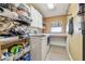 Functional laundry room with washer, dryer, storage shelves, and a folding counter for convenience at 1939 Heartland Cir, Valrico, FL 33594