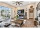 Bright living room with wood floors, fireplace, ceiling fan, and access to outdoor patio at 1939 Heartland Cir, Valrico, FL 33594