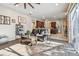 Bright and airy living room showcasing hardwood floors, large windows, and an open layout to kitchen at 1939 Heartland Cir, Valrico, FL 33594