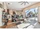 Spacious and sunny living room featuring wood floors, large windows, and an open floor plan at 1939 Heartland Cir, Valrico, FL 33594