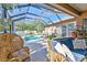Stylish outdoor space with pool view, featuring comfortable wicker furniture and a cozy ambiance at 1939 Heartland Cir, Valrico, FL 33594