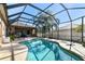 Serene backyard oasis with a sparkling pool, lush palms, and a screened-in patio for year-round enjoyment at 1939 Heartland Cir, Valrico, FL 33594