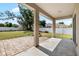 View of covered back patio with brick pavers and a built-in firepit, overlooking the spacious yard at 2019 Rutherford Dr, Dover, FL 33527