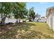 Large backyard with a white fence, offering privacy and plenty of space for outdoor activities and landscaping at 2019 Rutherford Dr, Dover, FL 33527