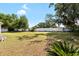 Spacious backyard enclosed by a white fence, offering privacy and room for outdoor activities and entertaining at 2019 Rutherford Dr, Dover, FL 33527