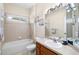 This bathroom features tile and a bath-shower combo and neutral colors at 2019 Rutherford Dr, Dover, FL 33527