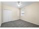 Bright bedroom with plush carpet, a ceiling fan, a large closet, and a well-lit window at 2019 Rutherford Dr, Dover, FL 33527