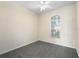 Cozy bedroom featuring a vaulted window and neutral-toned carpeting at 2019 Rutherford Dr, Dover, FL 33527