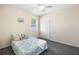 Cozy bedroom with soft carpet, bright window, and closet, perfect for relaxation at 2019 Rutherford Dr, Dover, FL 33527