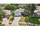 Aerial view of home with a three car garage, lush landscaping, and mature trees at 2019 Rutherford Dr, Dover, FL 33527