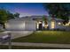 Charming single-Gathering home featuring a well-maintained lawn, three-car garage, and lush landscaping at 2019 Rutherford Dr, Dover, FL 33527