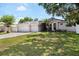 Beautiful single-Gathering home featuring a manicured front yard, mature trees, and a three-car garage at 2019 Rutherford Dr, Dover, FL 33527