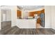 Open kitchen view showcasing breakfast bar, wood cabinets, and stainless steel refrigerator at 2019 Rutherford Dr, Dover, FL 33527