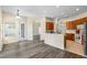 Bright, open-concept kitchen with warm wood cabinets and a breakfast bar, seamlessly flowing into the dining area at 2019 Rutherford Dr, Dover, FL 33527