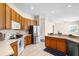 Spacious kitchen boasting stainless steel appliances, tile floors, and wooden cabinetry at 2019 Rutherford Dr, Dover, FL 33527