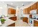 Well-lit kitchen featuring tile flooring, white countertops and wooden cabinetry at 2019 Rutherford Dr, Dover, FL 33527