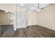 Bright living room with stylish wood-look floors and a view into other living spaces at 2019 Rutherford Dr, Dover, FL 33527