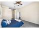 Primary bedroom including ceiling fan and sliding glass door with backyard views at 2019 Rutherford Dr, Dover, FL 33527