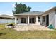 Exterior of home features a covered patio and brick pavers, perfect for enjoying the outdoor space at 2019 Rutherford Dr, Dover, FL 33527