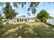 Expansive backyard with covered patio, perfect for enjoying the outdoors and entertaining guests at 2019 Rutherford Dr, Dover, FL 33527