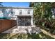 Beautifully designed backyard featuring a paver patio and screened in patio with white siding at 202 S Lincoln Ave, Tampa, FL 33609
