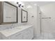 Elegant bathroom with double sinks, marble countertop and updated finishes at 202 S Lincoln Ave, Tampa, FL 33609