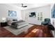 Stylish bedroom featuring hard floors, a ceiling fan, and bright, shuttered windows at 202 S Lincoln Ave, Tampa, FL 33609