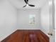 Empty bedroom featuring beautiful hardwood floors, white walls, and ceiling fan at 202 S Lincoln Ave, Tampa, FL 33609