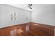 Bright bedroom features hardwood floors and plantation shutters on two windows at 202 S Lincoln Ave, Tampa, FL 33609