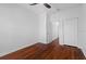 Simple bedroom with hardwood floors, white walls, and double door closet at 202 S Lincoln Ave, Tampa, FL 33609